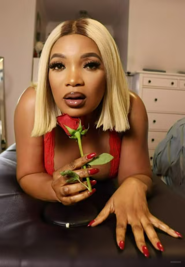 Sexy Lexi captivates in red lace lingerie while holding a rose with her blonde bob.